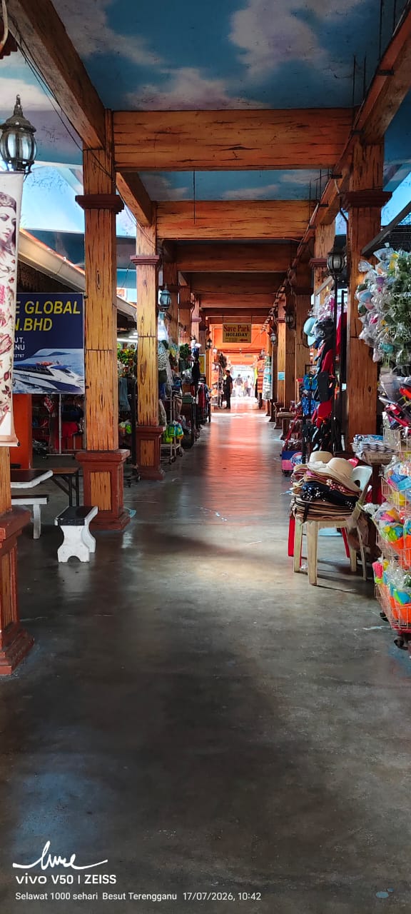 Covered walkway of shops leading to the Save Park Holiday office